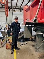 One of our technicians working on a customer truck with a smile!