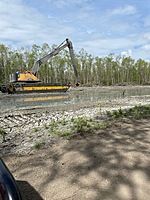 Even in the swamp, Scott Equipment is there. 